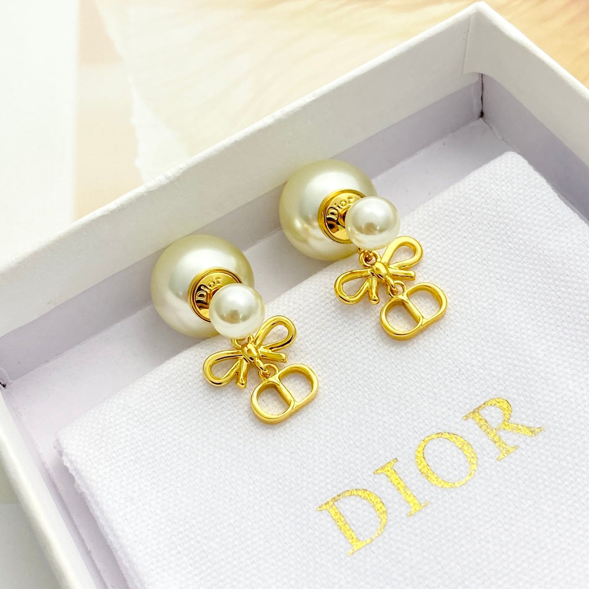Martin Graham stud earrings in polished metal-tone – close-up detail
