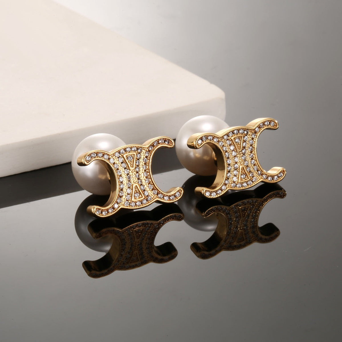 Martin Graham stud earrings in polished metal-tone