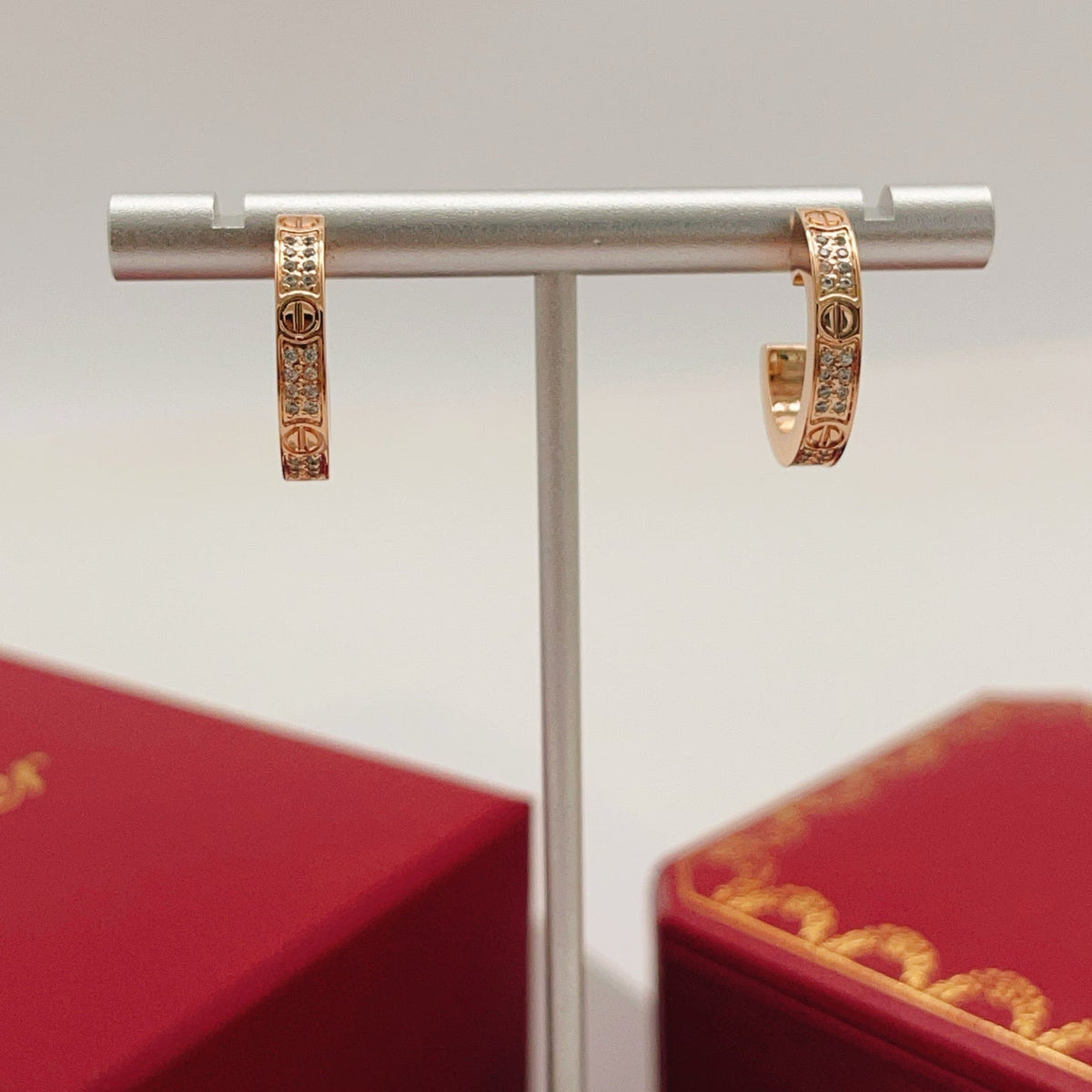 Martin Graham stud earrings in polished metal-tone – close-up detail