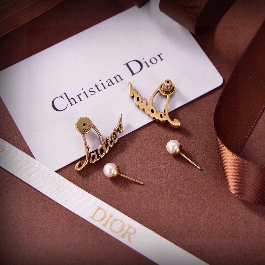 Martin Graham stud earrings in polished metal-tone – close-up detail