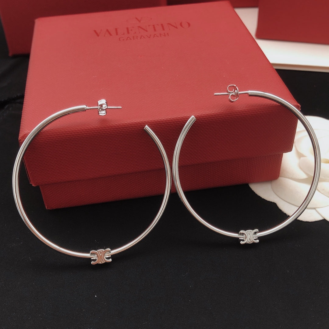 Martin Graham earrings in polished metal-tone