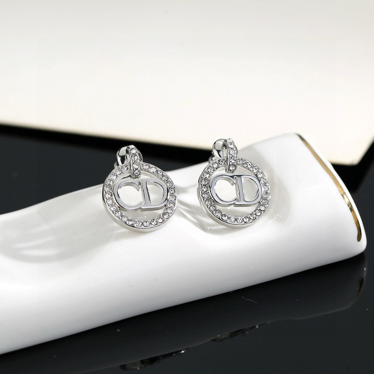 Martin Graham earrings in polished metal-tone – close-up detail