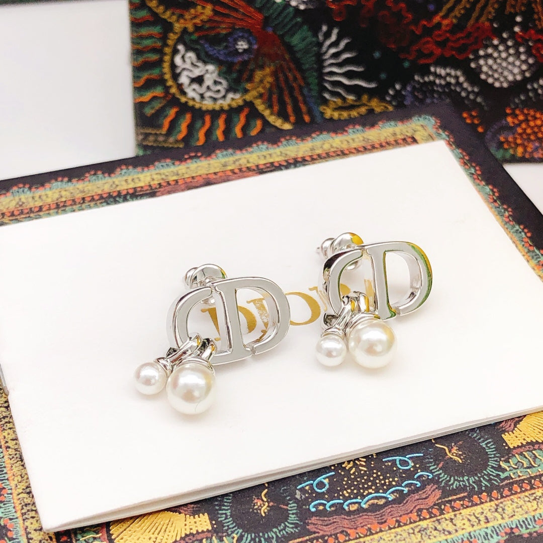 Martin Graham stud earrings in polished metal-tone – close-up detail