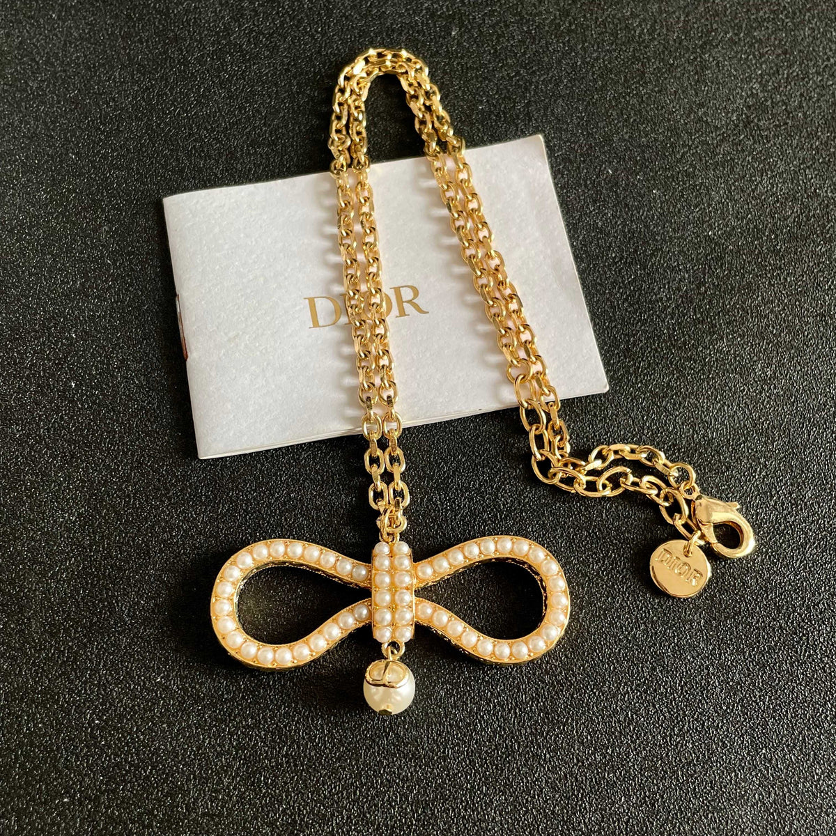 Martin Graham pendant necklace in polished metal-tone – front view