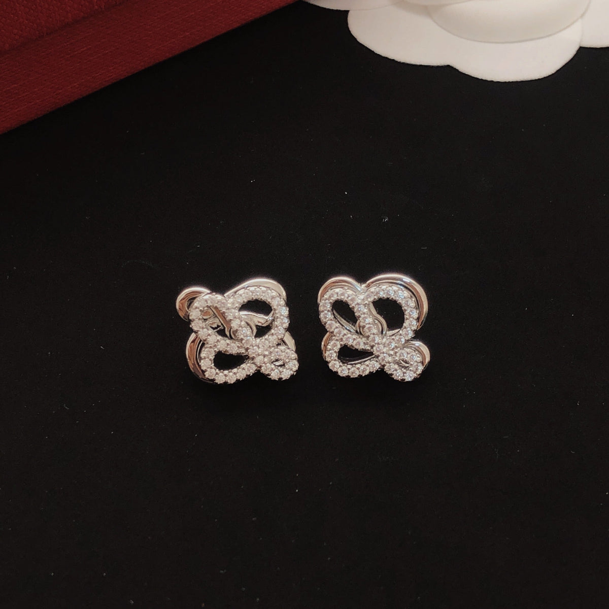 Martin Graham stud earrings in polished metal-tone – front view