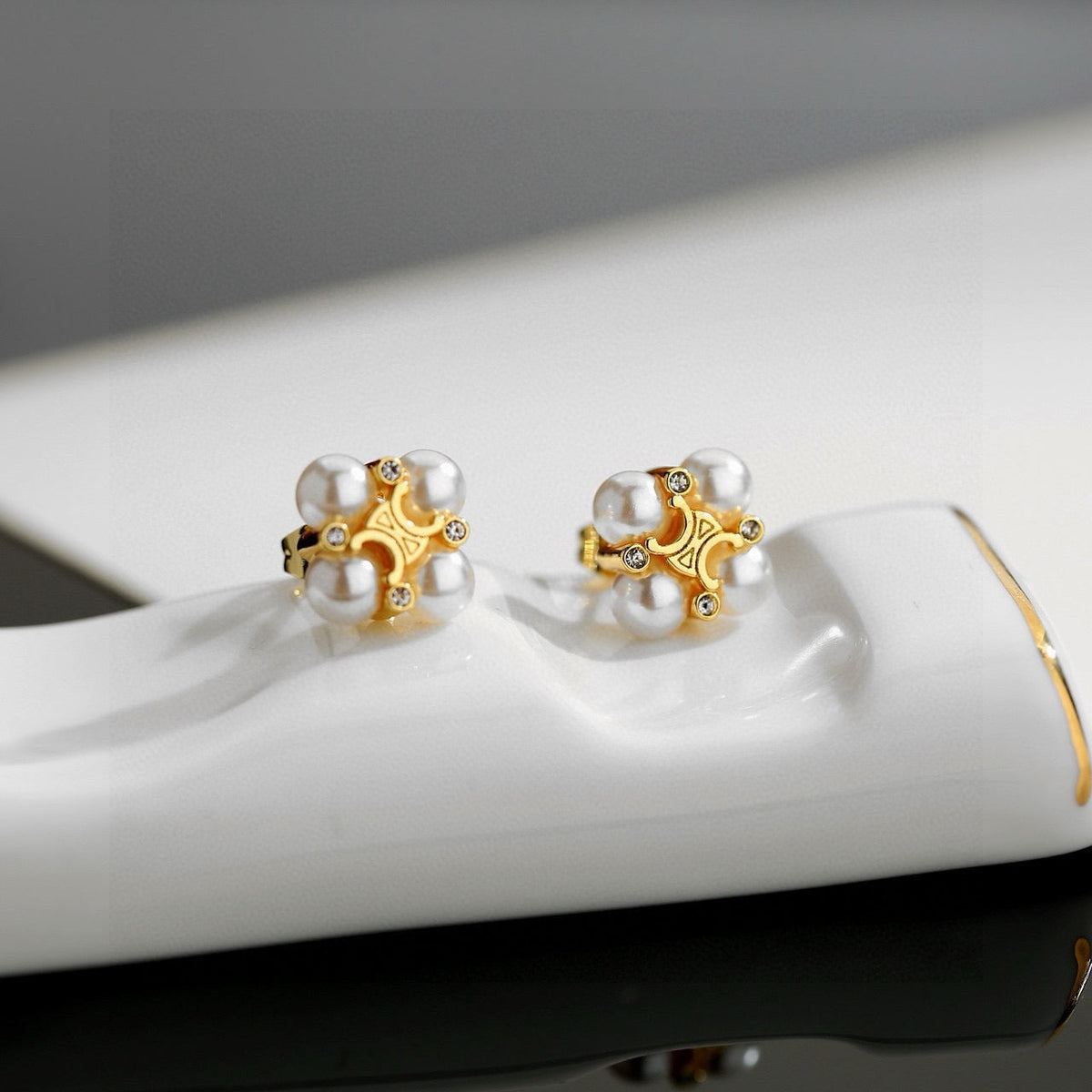 Martin Graham stud earrings in polished metal-tone – front view