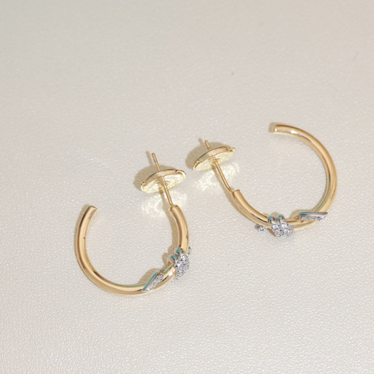 Martin Graham stud earrings in polished metal-tone – detail view