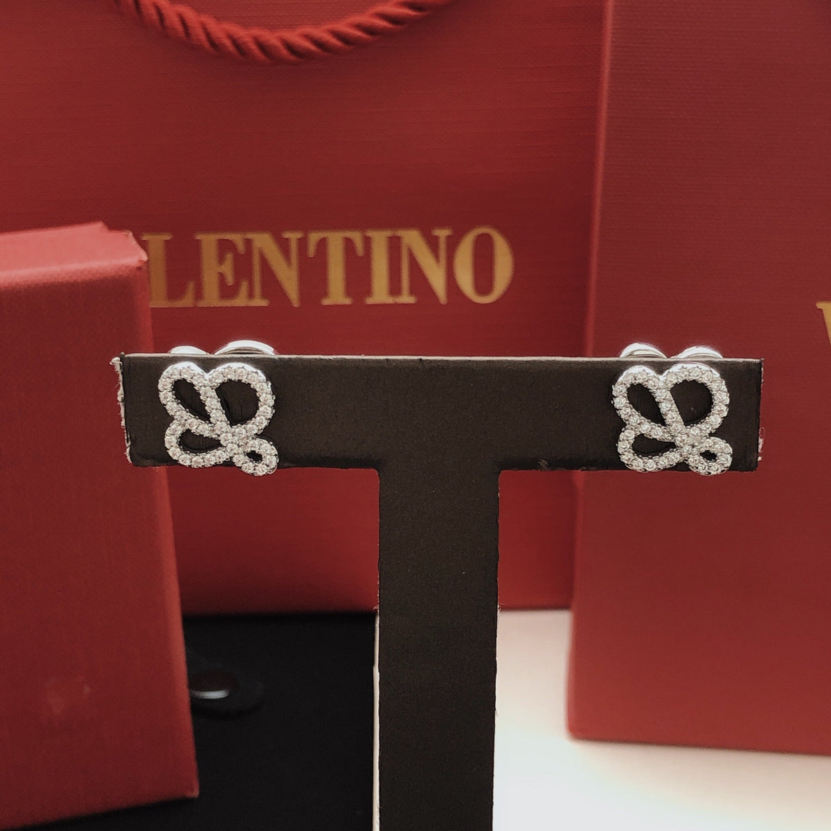 Martin Graham stud earrings in polished metal-tone – detail view