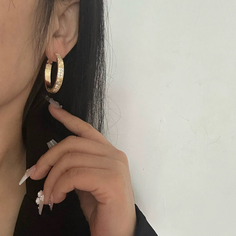 Martin Graham stud earrings in polished metal-tone – detail view