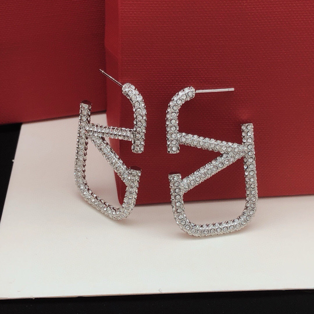 Martin Graham stud earrings in polished metal-tone – detail view